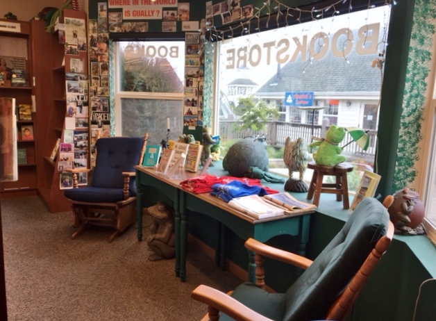 Interior of Four Eyed Frog Books, with chairs and a table by the picture window