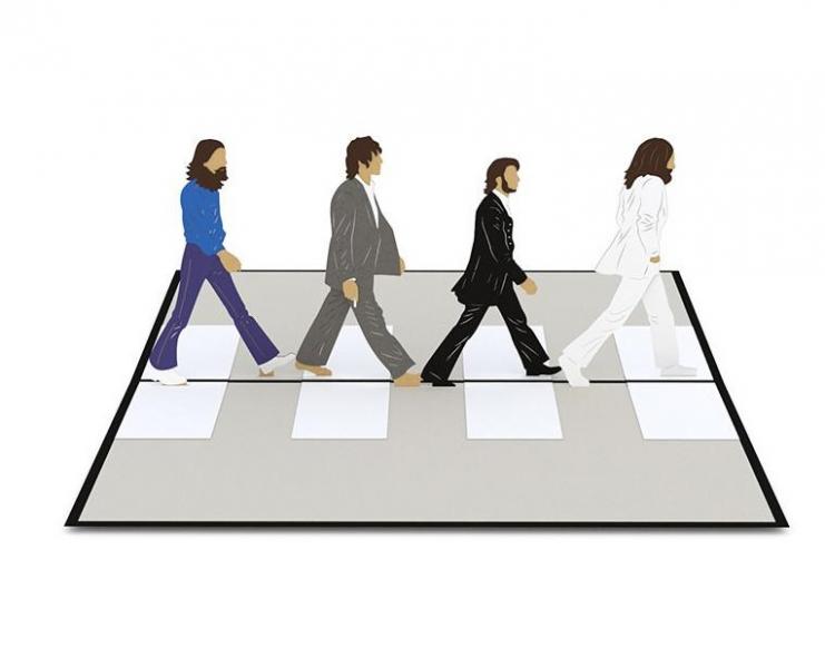 A Lovepop card featuring The Beatles recalls the iconic image of the foursome crossing Abbey Road.