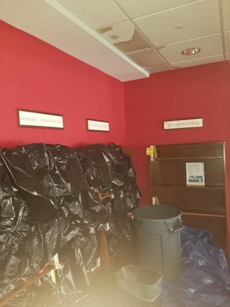 Staff at Quail Ridge covered book shelves with garbage bags during clean up.