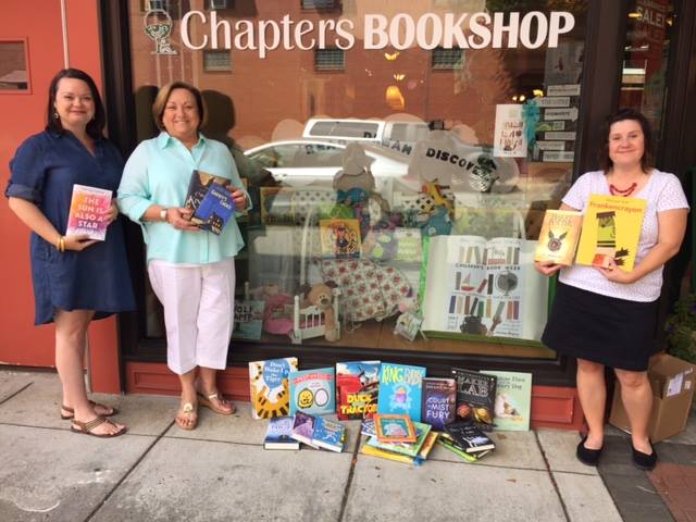 Staff from Chapters Bookshop with a set of books for donation