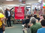 ABA CEO Oren Teicher presents a commemorative banner at Doylestown Bookshop