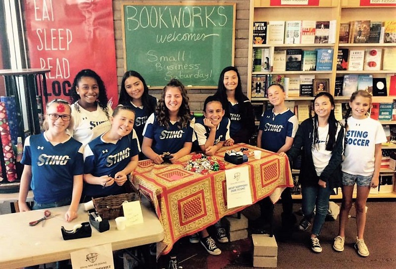 Albuquerque’s Sting Force soccer team wraps gifts at Bookworks for Indies First.