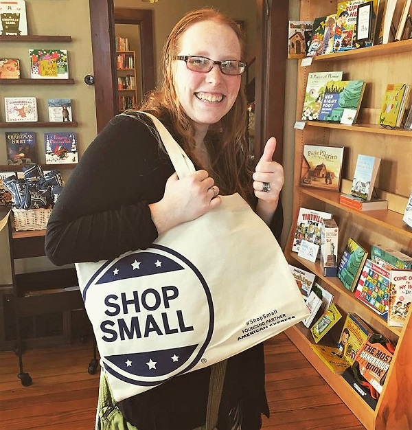 A shopper at Neighborhood Reads snags a tote.