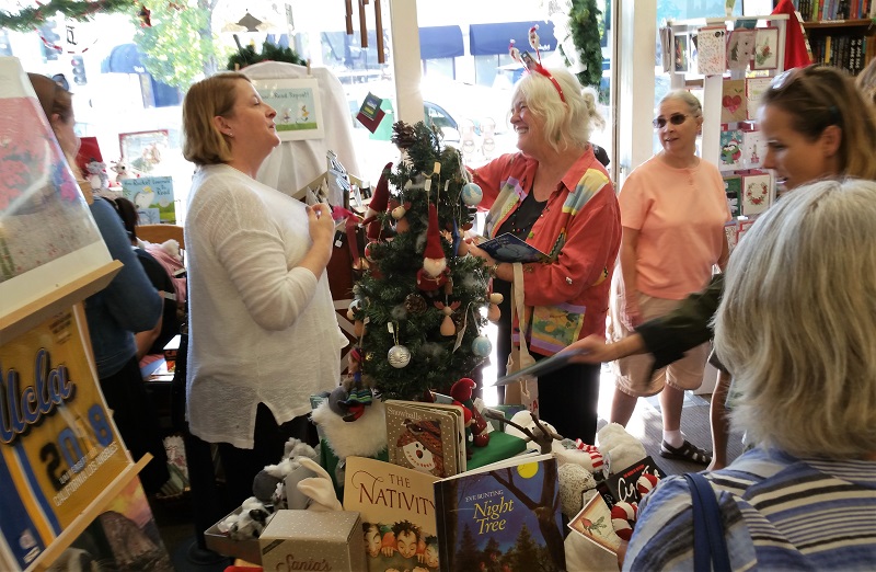 Author Ann Whitford Paul, center, greets shoppers at Once Upon A Time.