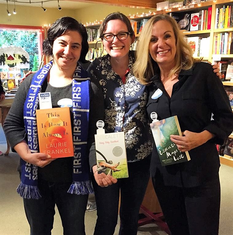 Authors Laurie Frankel, left, and Deb Caletti, right, flank bookseller Tegan Tigani at Queen Anne Book Company.