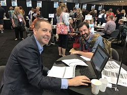 Michael Becher of Industry Insights with a bookseller in the ABA Lounge at BookExpo