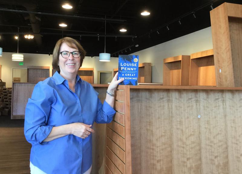 Barbara Jeremiah holds a copy of a Louise Penny novel, the first title to arrive at her new store, Riverstone Books in Pittsburgh.