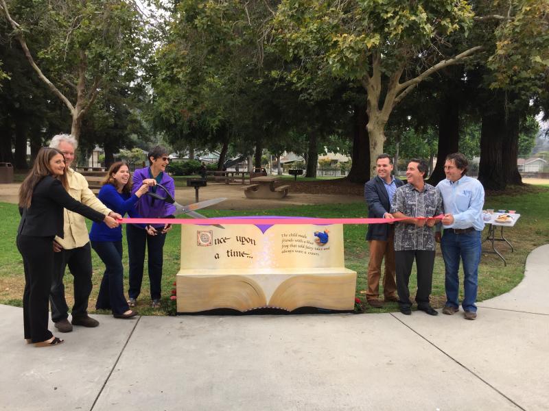 The ribbon cutting ceremony for Bookshop Santa Cruz’s first artful reading bench, at the Grant Street Park playground.