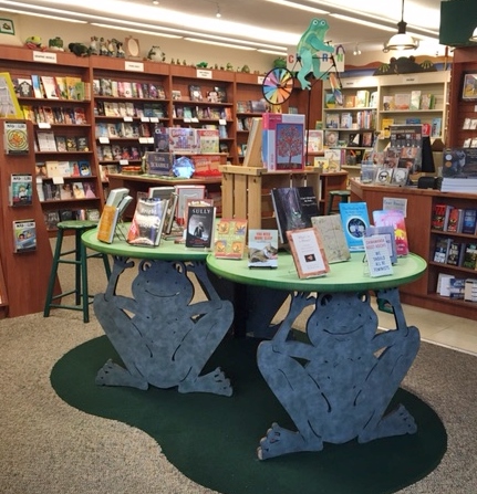 Interior of Four Eyed Frog Books, with frog-themed tables