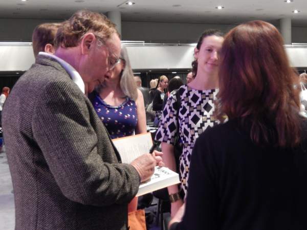 Indie Champion Award winner James Patterson autographs for fans after the luncheon.