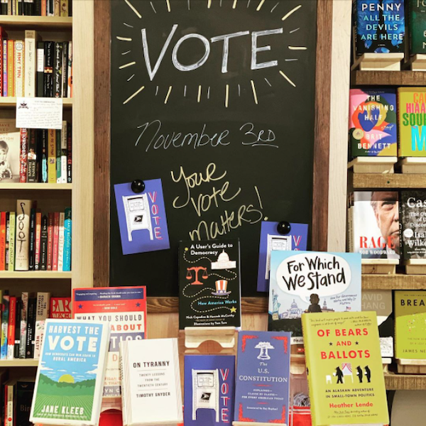Chalkboard encouraging "vote" behind a book display on related titles