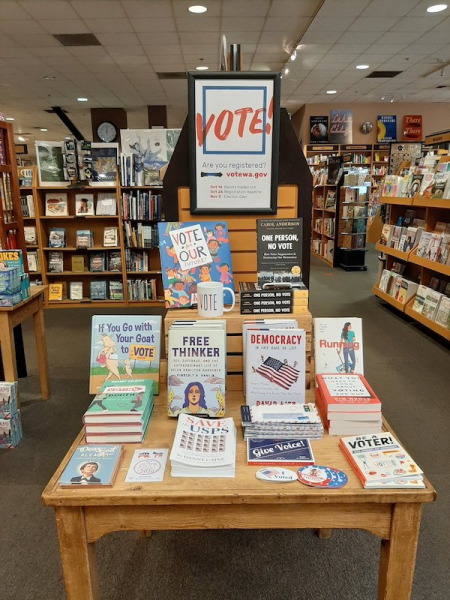Vote! sign above display of books