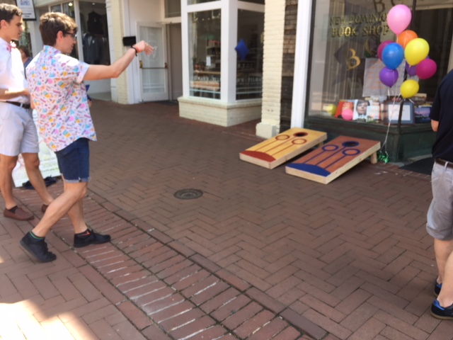 Cornhole players take their shot outside New Dominion Books in Charlottesville, Virginia.
