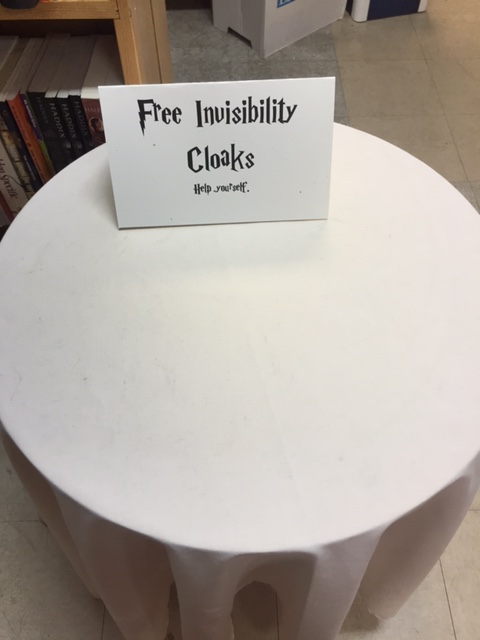 Table with "free invisibility cloaks."